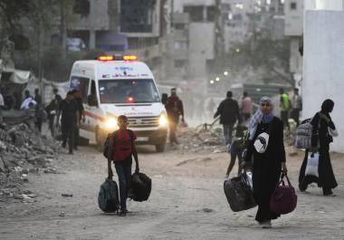 Palestinos se marchan con sus pertenencias tras la orden israelí para evacuar varias escuelas y un hospital en el vecindario de Rimal, en la Ciudad de Gaza, el 14 de mayo de 2025. FOTO: